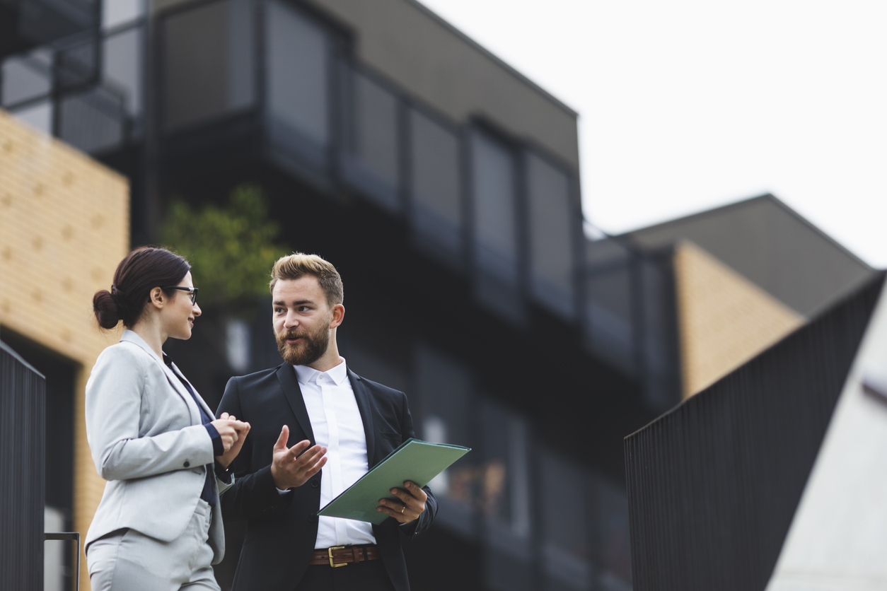 Two business people talking about Auckland Property Affordability